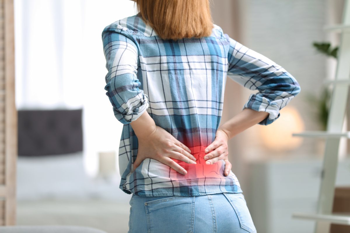 Woman holding her lower back in pain